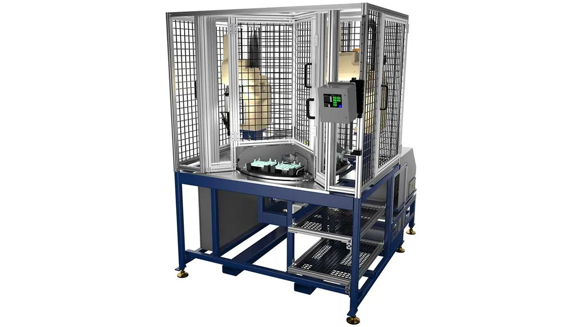 A guarded assembly automation cell on a steel frame, its tooling visible inside the enclosure.
