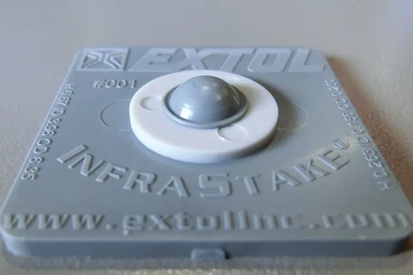 An Extol InfraStake test plaque, a staked boss formed into a smooth dome.